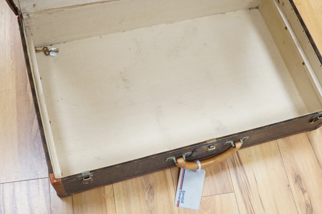 A vintage Louis Vuitton monogram suitcase with two original keys, numbered 793692 to the linen covered interior, height 22cm, width 76cm, depth 46cm